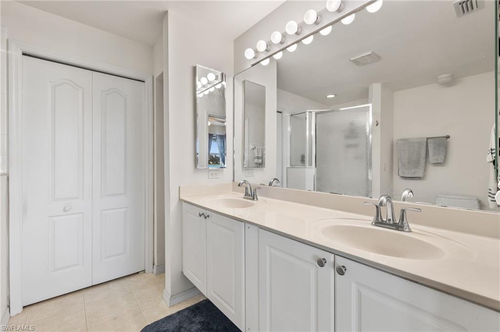 1953 Crestview Way, Unit 161 Naples, FL 34119 - Photo 18 of 37 a bathroom with double sink and a mirror