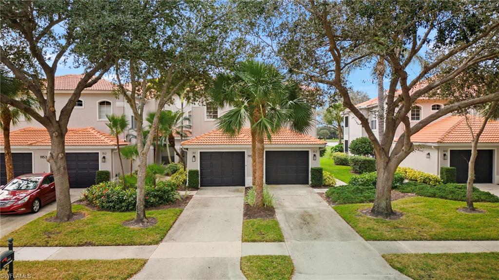 1953 Crestview Way, Unit 161 Naples, FL 34119 - Photo 2 of 37 a front view of a house with a yard and potted plants