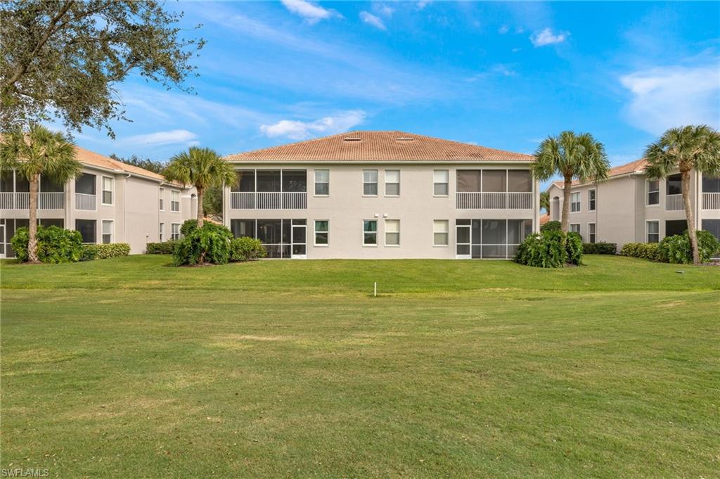 1953 Crestview Way, Unit 161 Naples, FL 34119 - Photo 28 of 37 a front view of a building with a garden