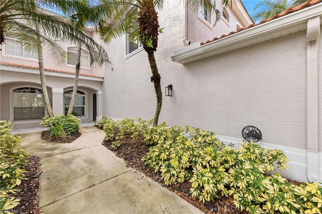 1953 Crestview Way, Unit 161 Naples, FL 34119 - Photo 3 of 37 a front view of a house with garden