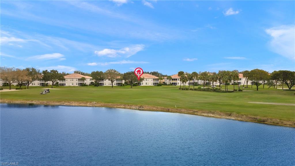 1953 Crestview Way, Unit 161 Naples, FL 34119 - Photo 33 of 37 a view of a lake with houses in the background