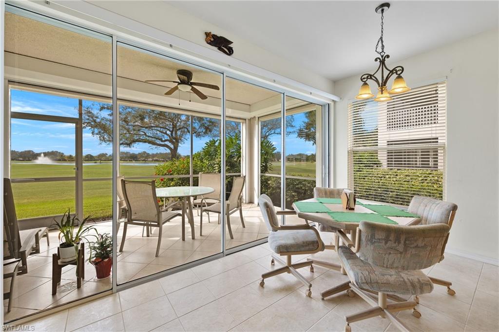 1953 Crestview Way, Unit 161 Naples, FL 34119 - Photo 4 of 37 a dining room with furniture water view and a floor to ceiling window
