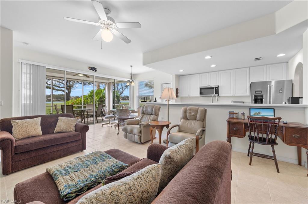 1953 Crestview Way, Unit 161 Naples, FL 34119 - Photo 5 of 37 a living room with furniture kitchen view and a large window