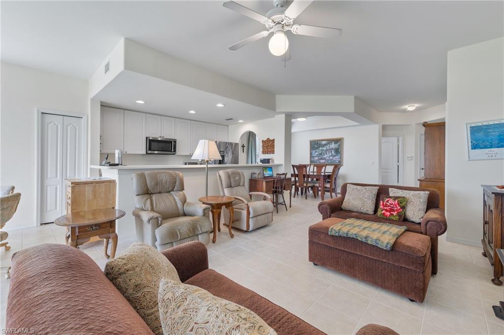 1953 Crestview Way, Unit 161 Naples, FL 34119 - Photo 6 of 37 a living room with furniture kitchen view and a chandelier