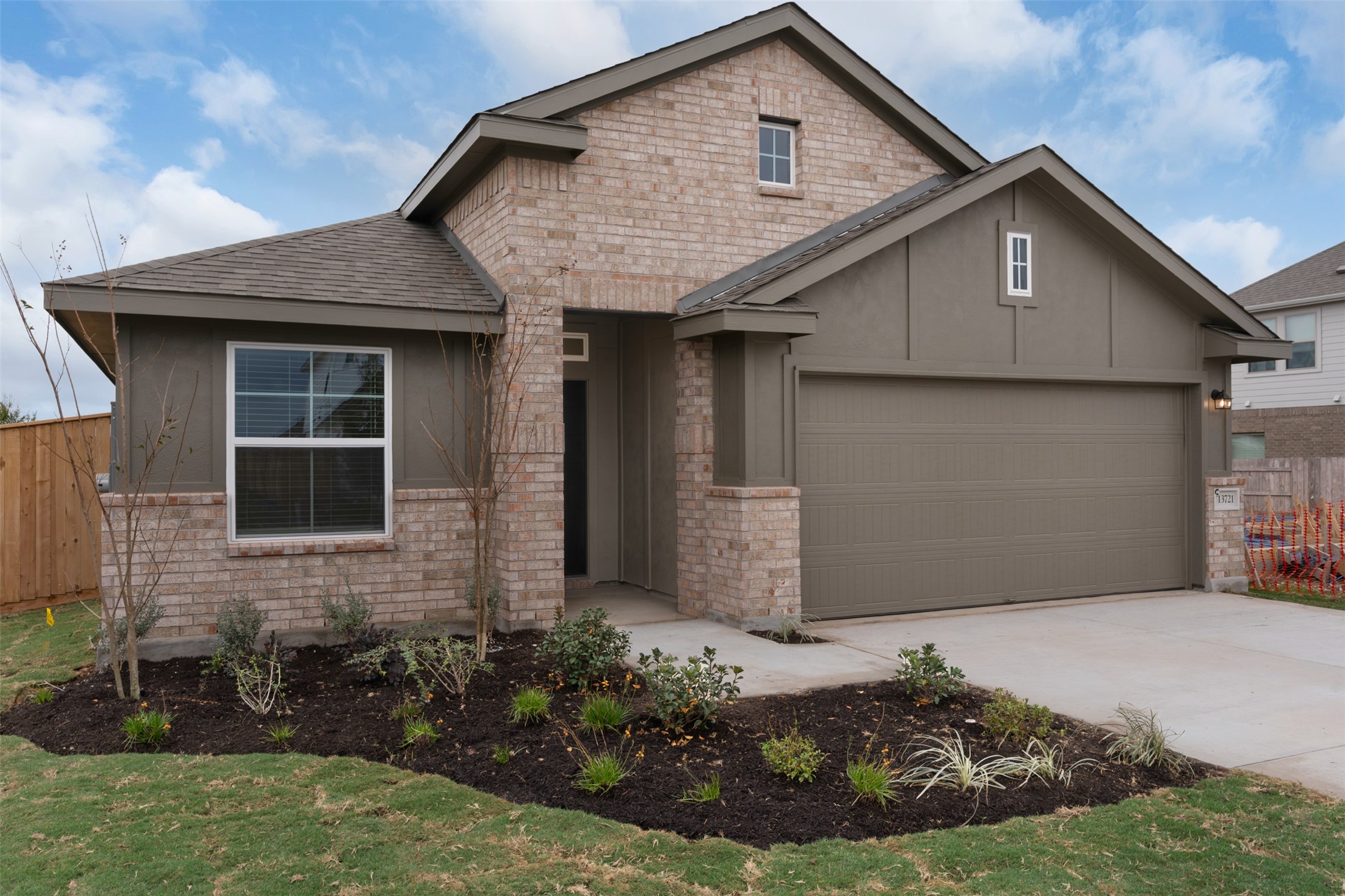 13721 Tucker Hedge Pass Elgin, TX 78621 - Photo 2 of 28 View of front of house featuring driveway, roof with shingles, and brick siding