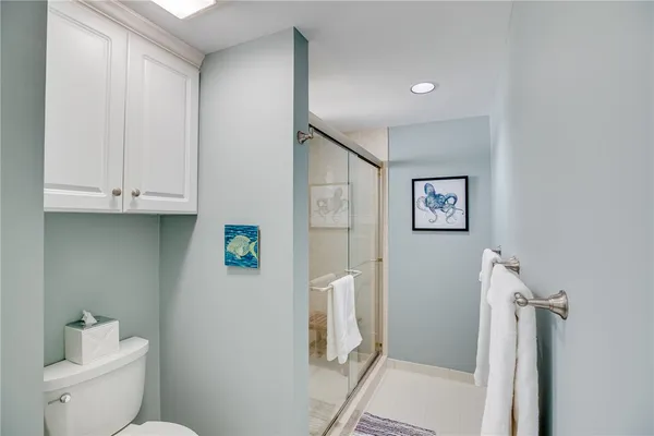 a bathroom with a toilet and a shower