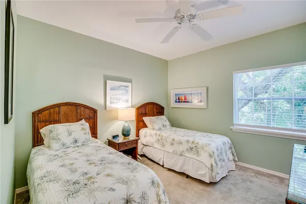 a bedroom with two beds and a window