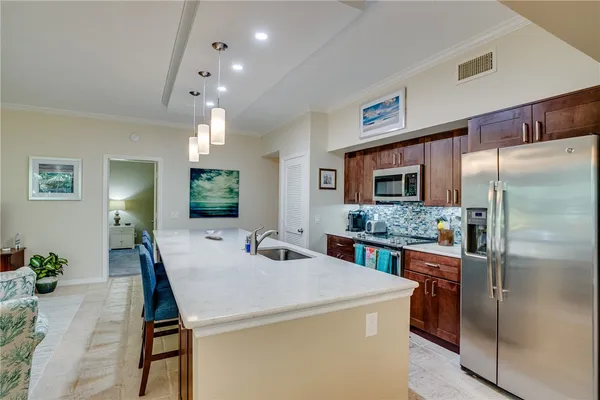 a kitchen with a stove a refrigerator and a dining table