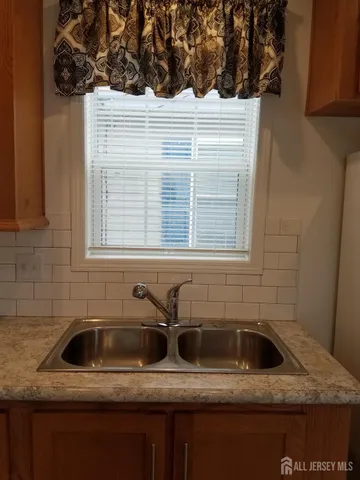 a bathroom with a sink and a window