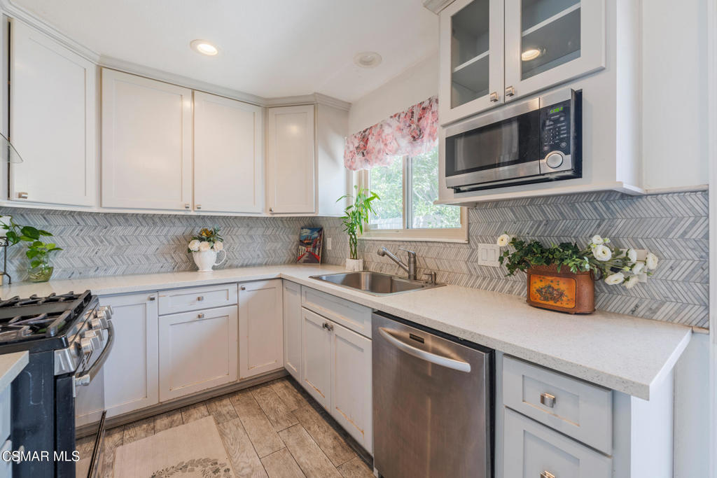 1917 Fitzgerald Road Simi Valley, CA 93065 - Photo 13 of 55 a kitchen with stainless steel appliances white cabinets and a stove top oven