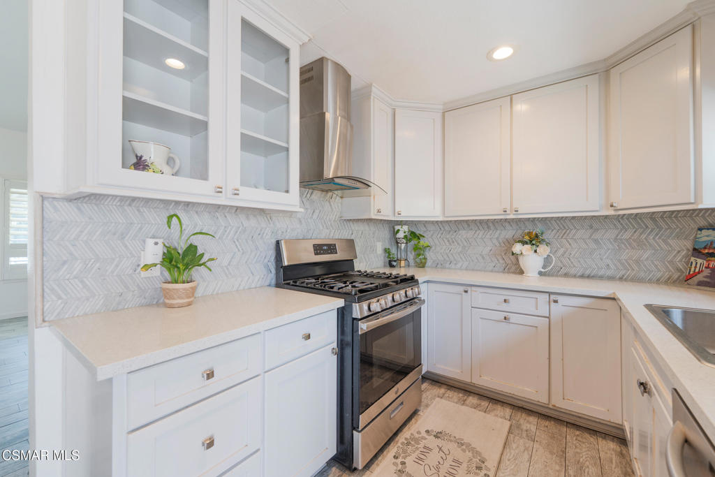 1917 Fitzgerald Road Simi Valley, CA 93065 - Photo 27 of 55 a kitchen with stainless steel appliances white cabinets and a stove top oven