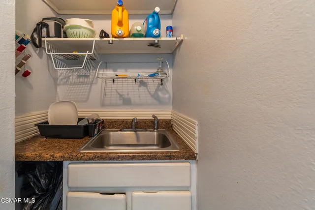 a bathroom with a sink a toilet and shower curtain