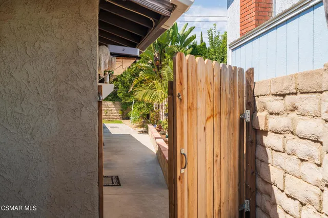 a view of backyard with seating area and green space