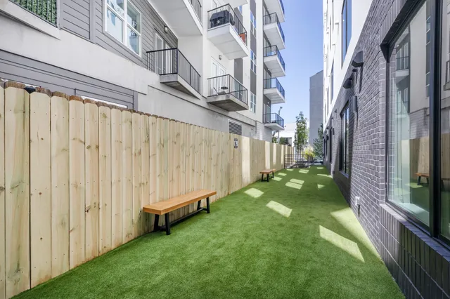 a kitchen with stainless steel appliances a dining table and chairs