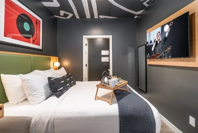 a living room with stainless steel appliances kitchen island furniture and a window