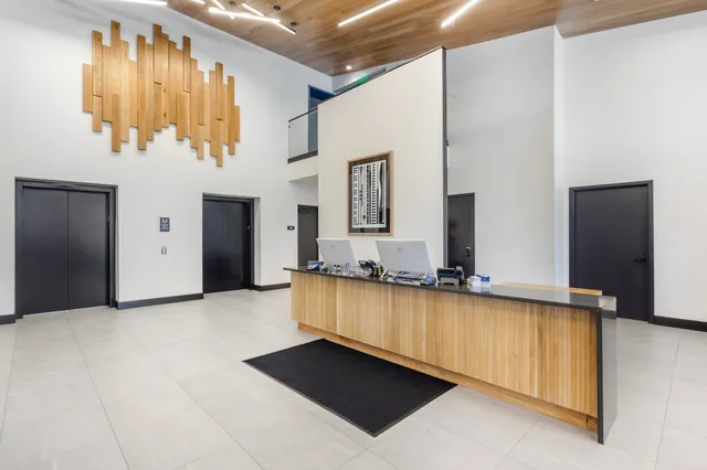 a view of a kitchen with a sink and a large mirror