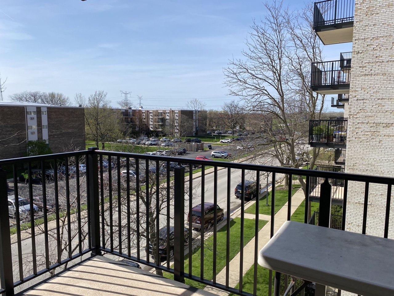 9128 West Terrace Drive, Unit 4B Niles, IL 60714 - Photo 10 of 24 a view of a balcony with wooden floor and fence