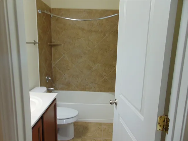 a bathroom with a toilet a sink and shower