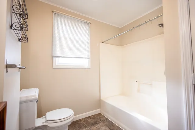 a bathroom with a toilet and a bathtub