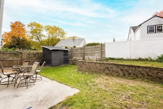 a view of a backyard with sitting area
