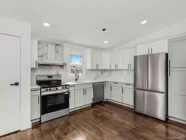 a kitchen with a refrigerator stove and wooden cabinets