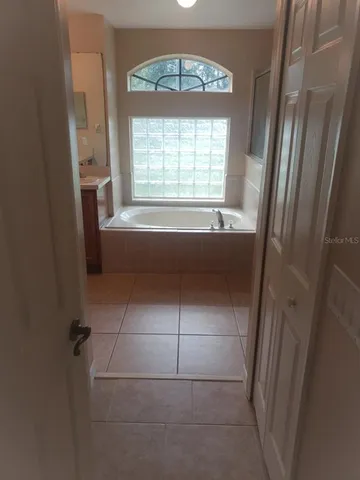 a bathroom with a bathtub and a window