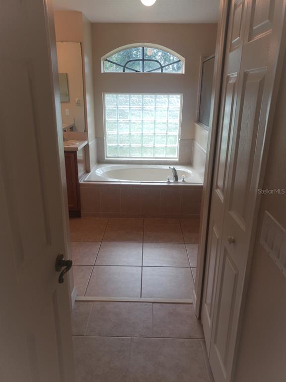 1 Westmar Place Palm Coast, FL 32164 - Photo 14 of 38 a bathroom with a bathtub and a window