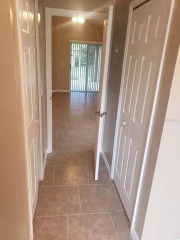 an empty room with a empty space and windows