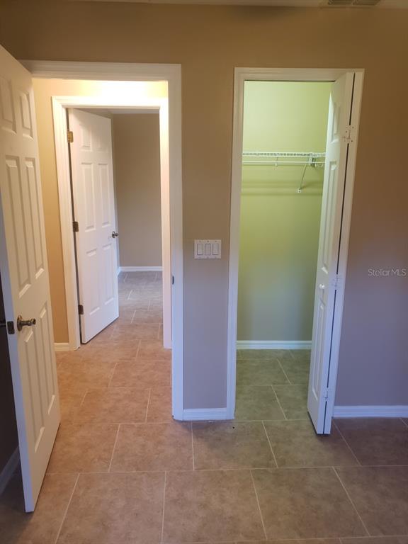 1 Westmar Place Palm Coast, FL 32164 - Photo 22 of 38 an empty room with closet and a mirror