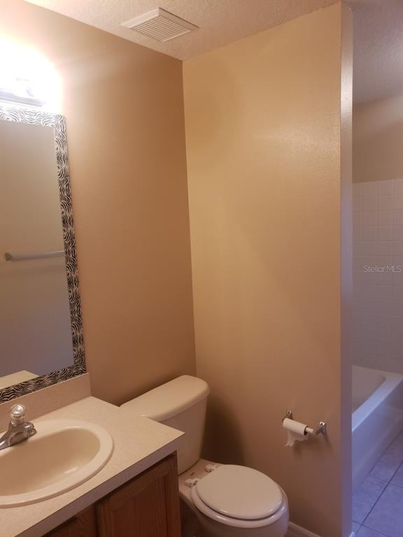 1 Westmar Place Palm Coast, FL 32164 - Photo 29 of 38 a bathroom with a sink a toilet and mirror