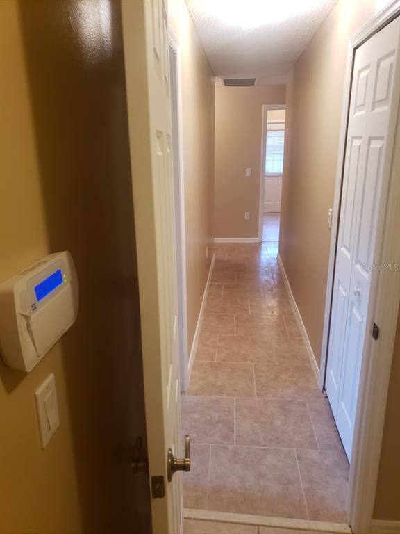 1 Westmar Place Palm Coast, FL 32164 - Photo 33 of 38 a hallway with sliding door and yard in back