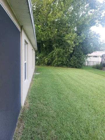 a view of a house with backyard porch and garden