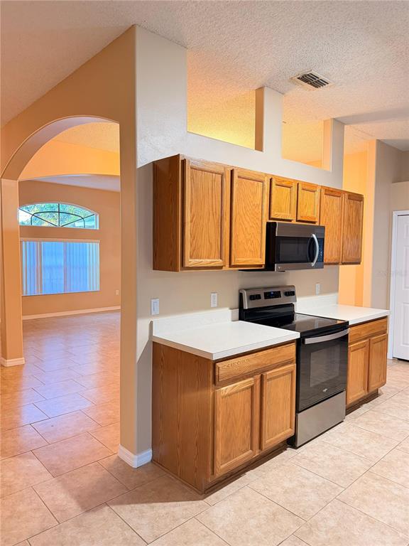 1 Westmar Place Palm Coast, FL 32164 - Photo 8 of 38 a kitchen with stainless steel appliances granite countertop a stove a sink and a microwave