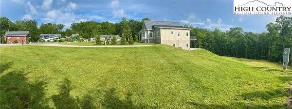a view of house with outdoor space and garden