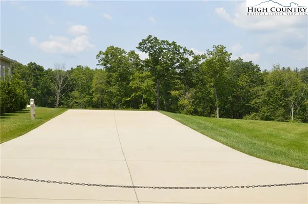 a view of a field of grass and trees