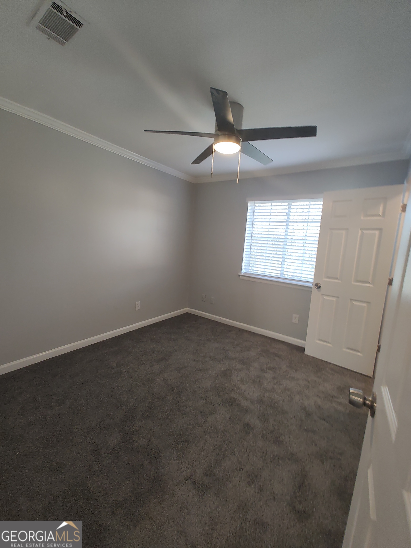 1625 Conley Road, Unit 275 Conley, GA 30288 - Photo 13 of 15 an empty room with windows and fan