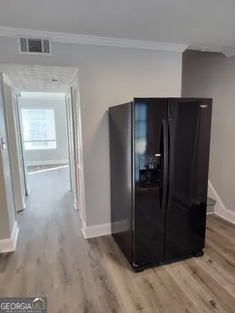 a view of a hallway with wooden floor