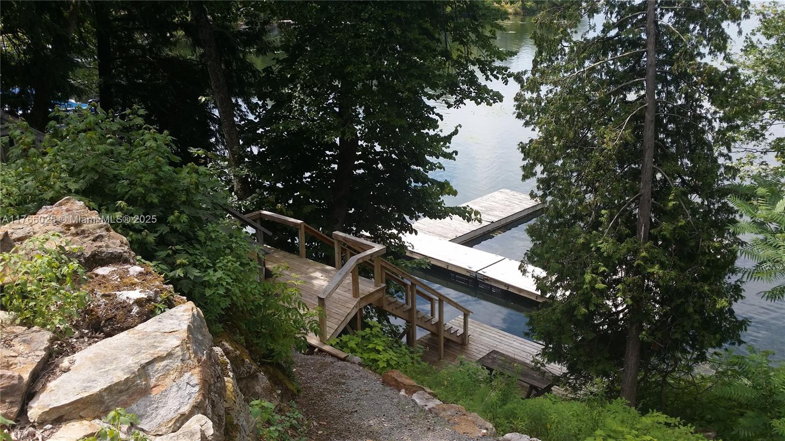 18435 Otter Point Road Wellesley Island, NY 13640 - Photo 11 of 27 a backyard of a house with lots of green space