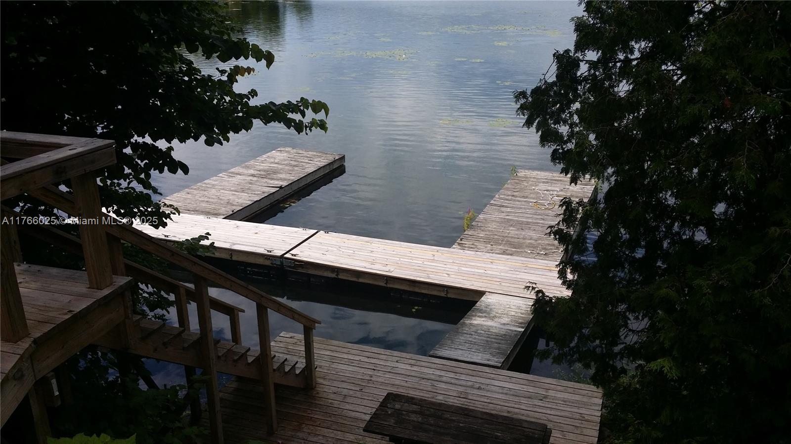 18435 Otter Point Road Wellesley Island, NY 13640 - Photo 14 of 27 a backyard of a house with table and chairs