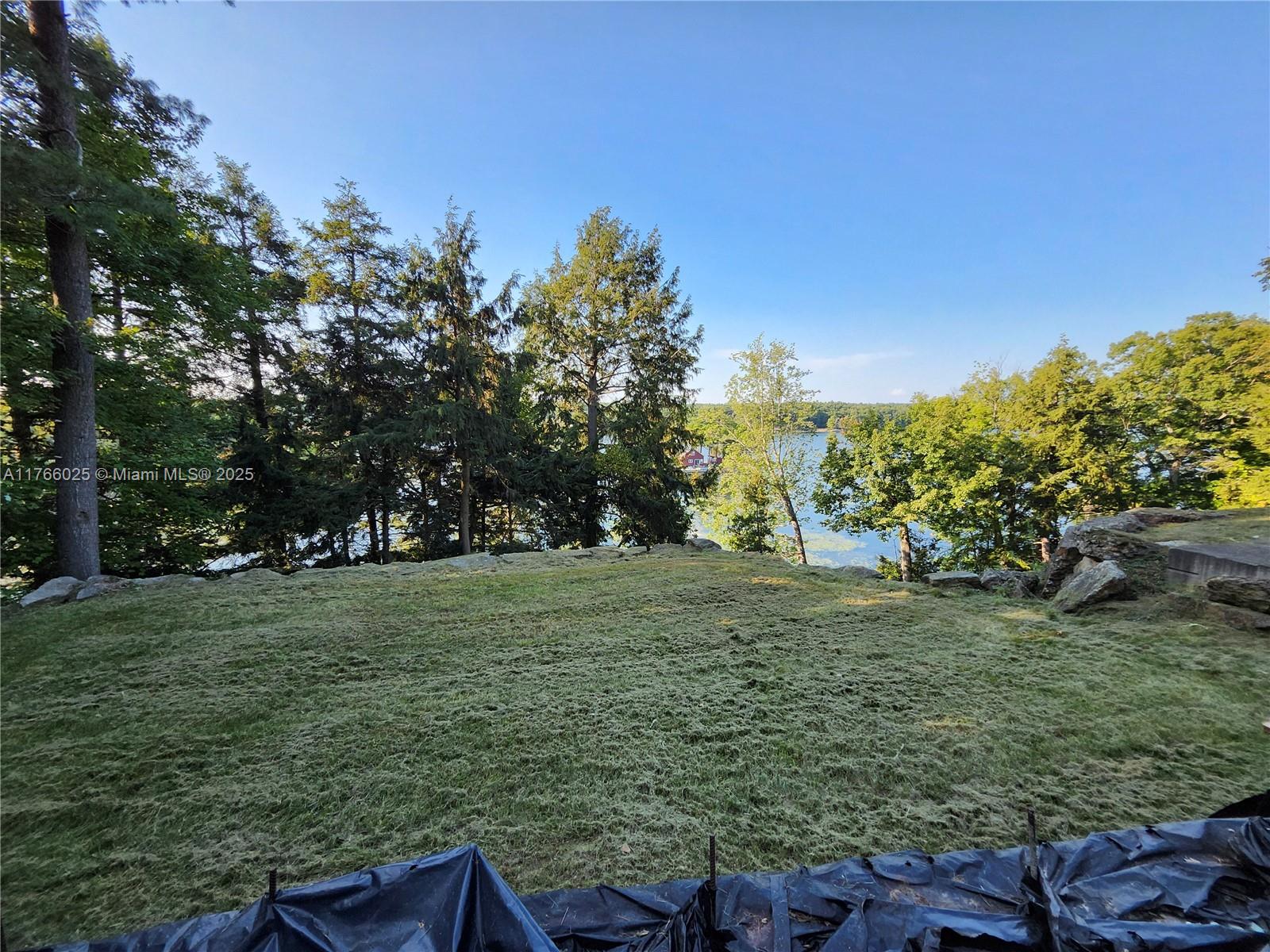 18435 Otter Point Road Wellesley Island, NY 13640 - Photo 6 of 27 a backyard of a house with lots of green space