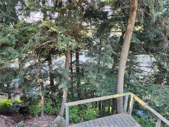 a balcony with wooden fence and trees