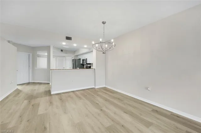 a kitchen with stainless steel appliances granite countertop a sink and white cabinets