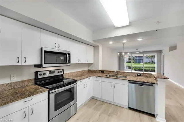 wooden floor in an empty room with a kitchen