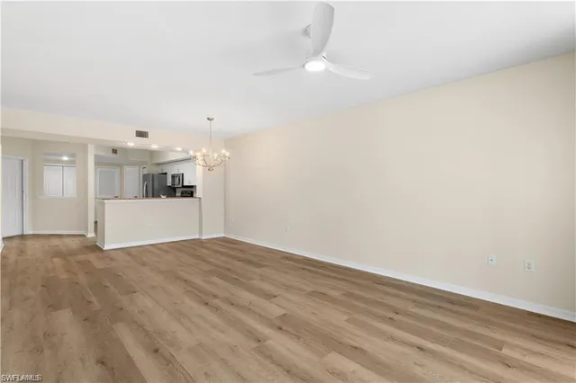 a view of a white wall with wooden floor