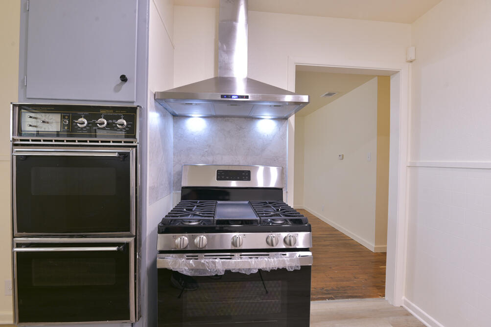3013 2nd Street Lubbock, TX 79415 - Photo 11 of 21 a kitchen with a stove and a refrigerator