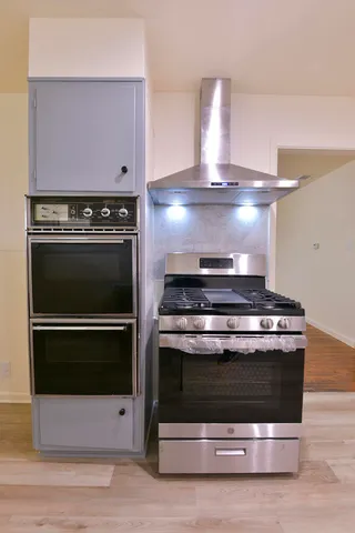 a stove top oven sitting inside of a kitchen