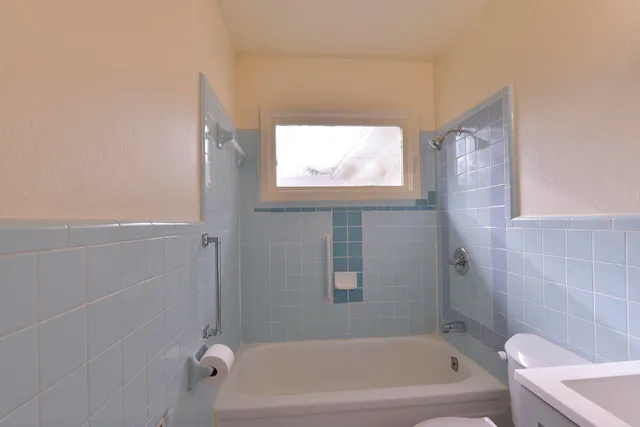a bathroom with a bathtub and window