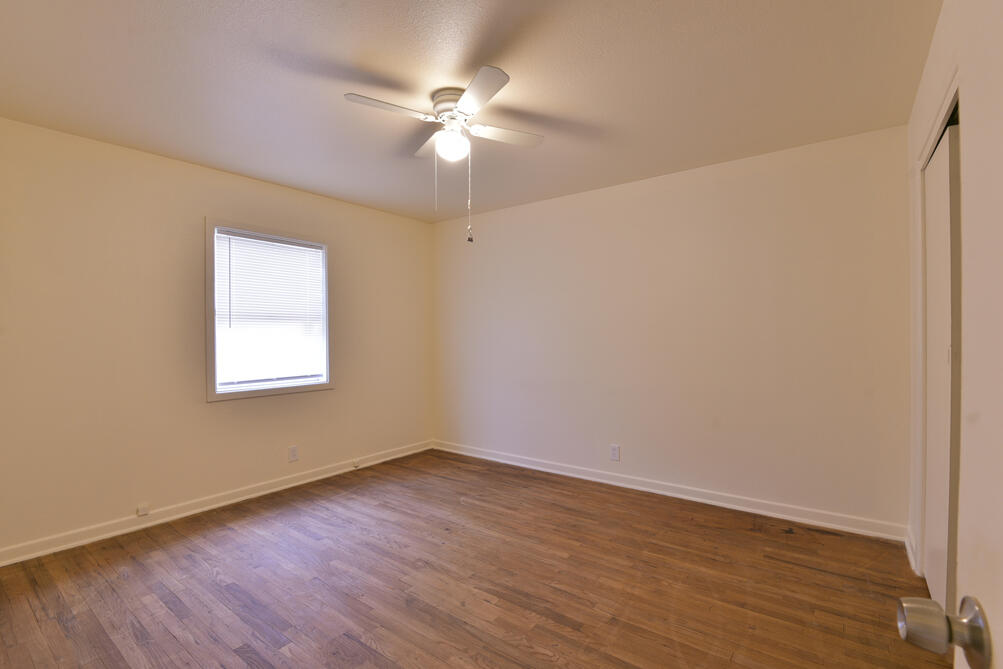 3013 2nd Street Lubbock, TX 79415 - Photo 16 of 21 an empty room with wooden floor fan and windows