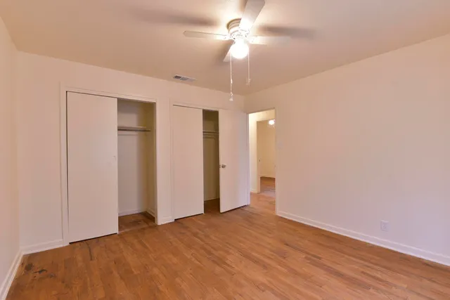 a view of empty room with wooden floor