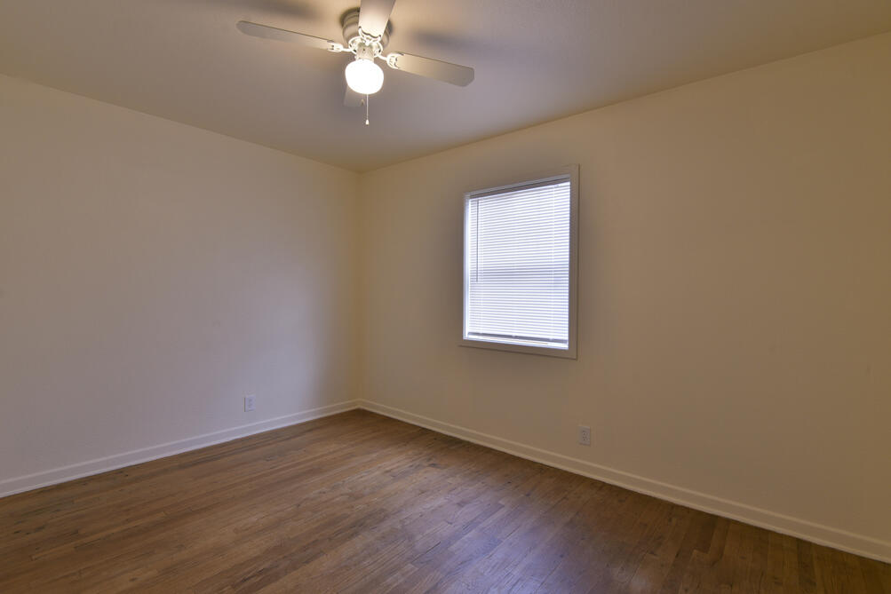 3013 2nd Street Lubbock, TX 79415 - Photo 18 of 21 an empty room with wooden floor and windows
